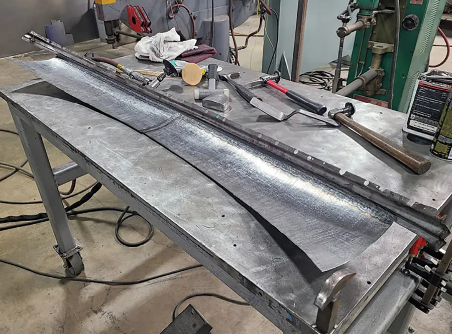 Here are the two shaped pieces of the front section welded together with the edge of the widened windshield lip added.
