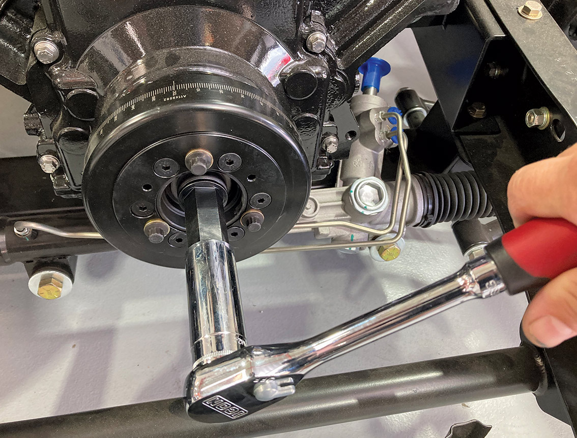 Close up of a SFI-approved crank damper being installed