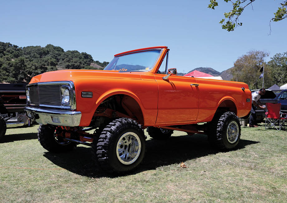 orange C10 truck with large wheels