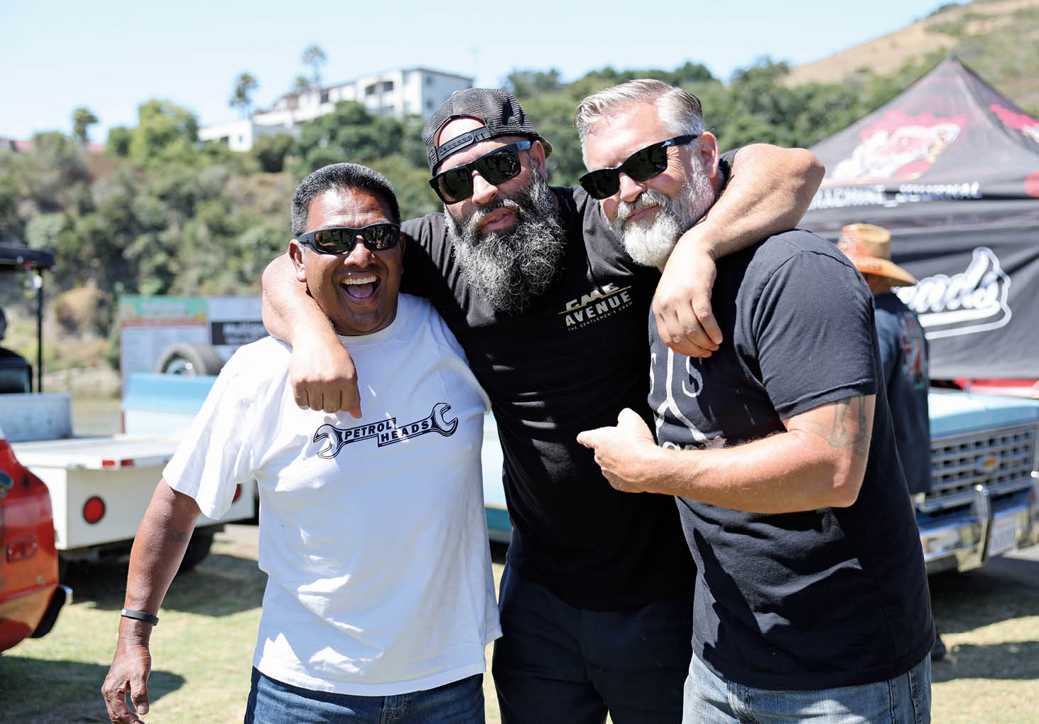 3 friends smile and hug at C10 SLO Down 2023