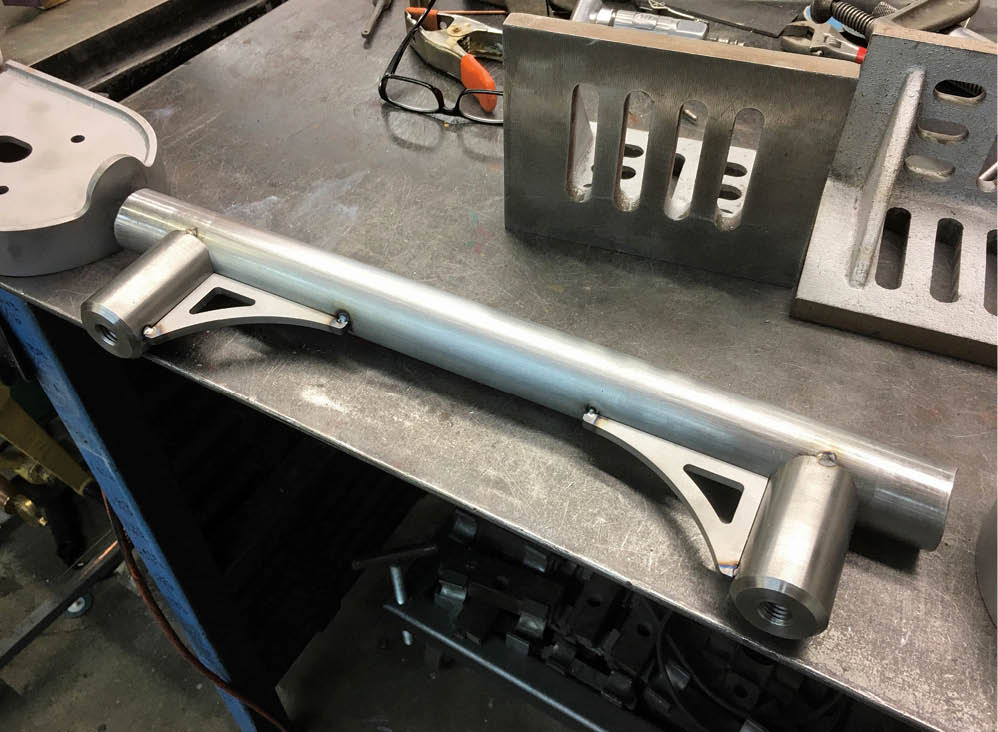 These components for the rear suspension crossmember are being preassembled on the bench.