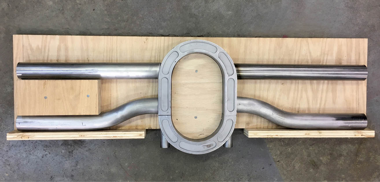 A simple plywood fixture was made to properly align all the components for the crossmember for welding.