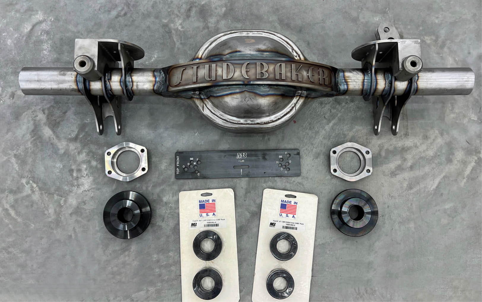 The ends were trimmed off the axle housing and the brackets were slipped into place. After careful fitting they were finish welded. Some components of the Mittler Bros. axle narrowing kit are shown.