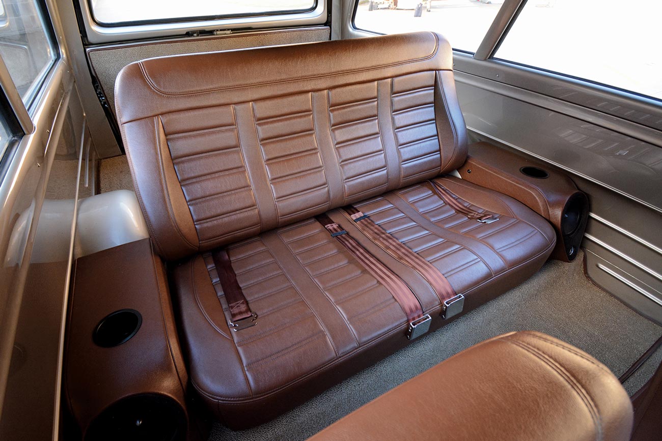 from the front passenger seat, view at the Chevy Suburban's rear brown leather seating