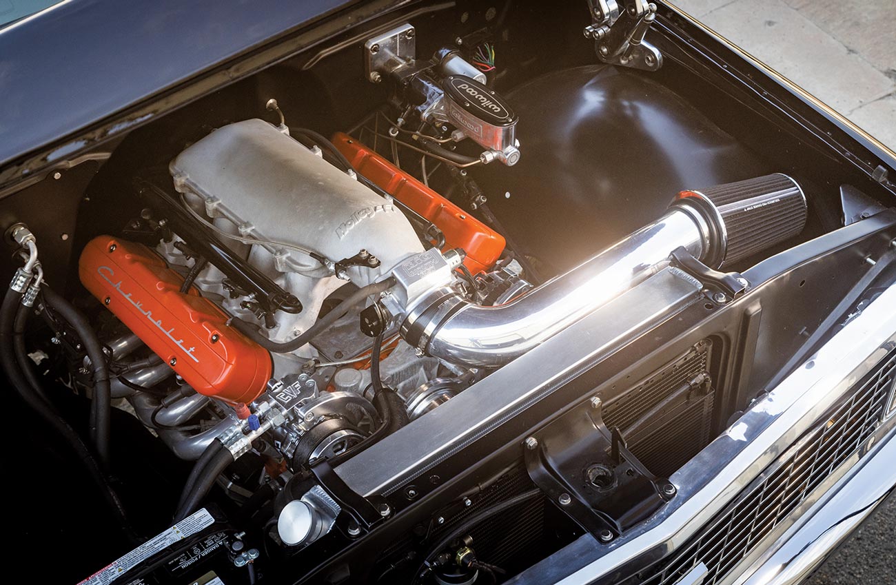 black Chevy K10 engine with bright orange Chevrolet valve covers