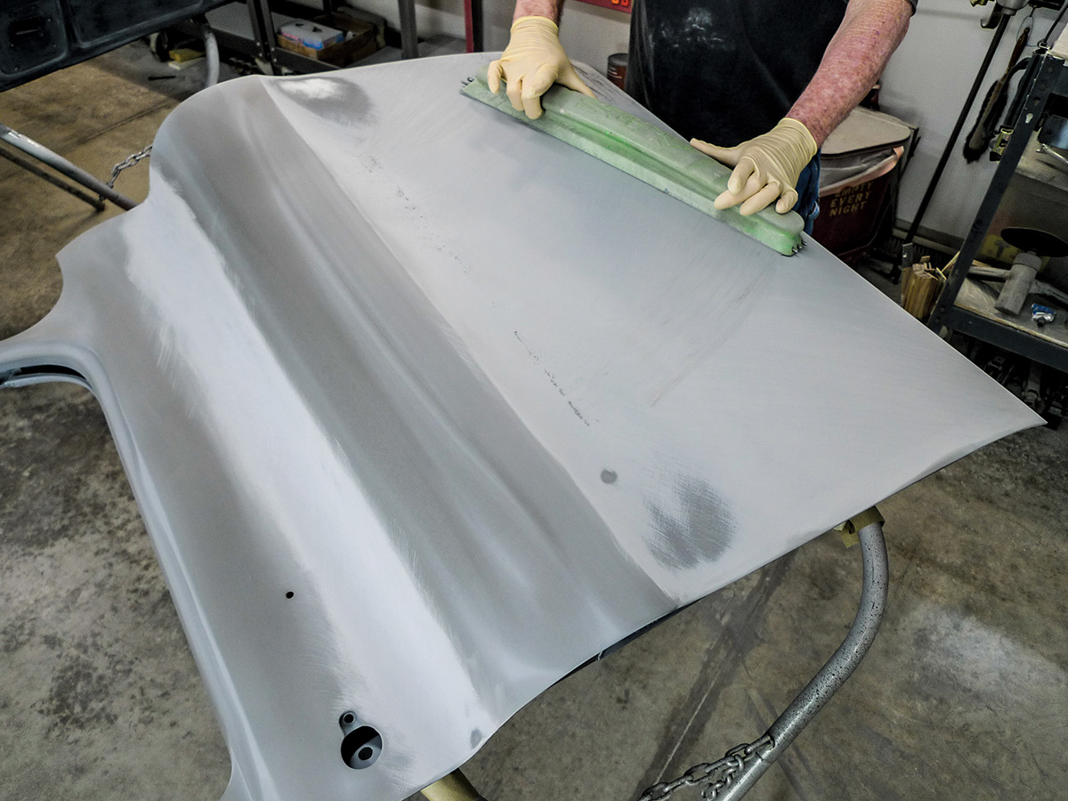 Hands using a fairing block on the exterior of the car door