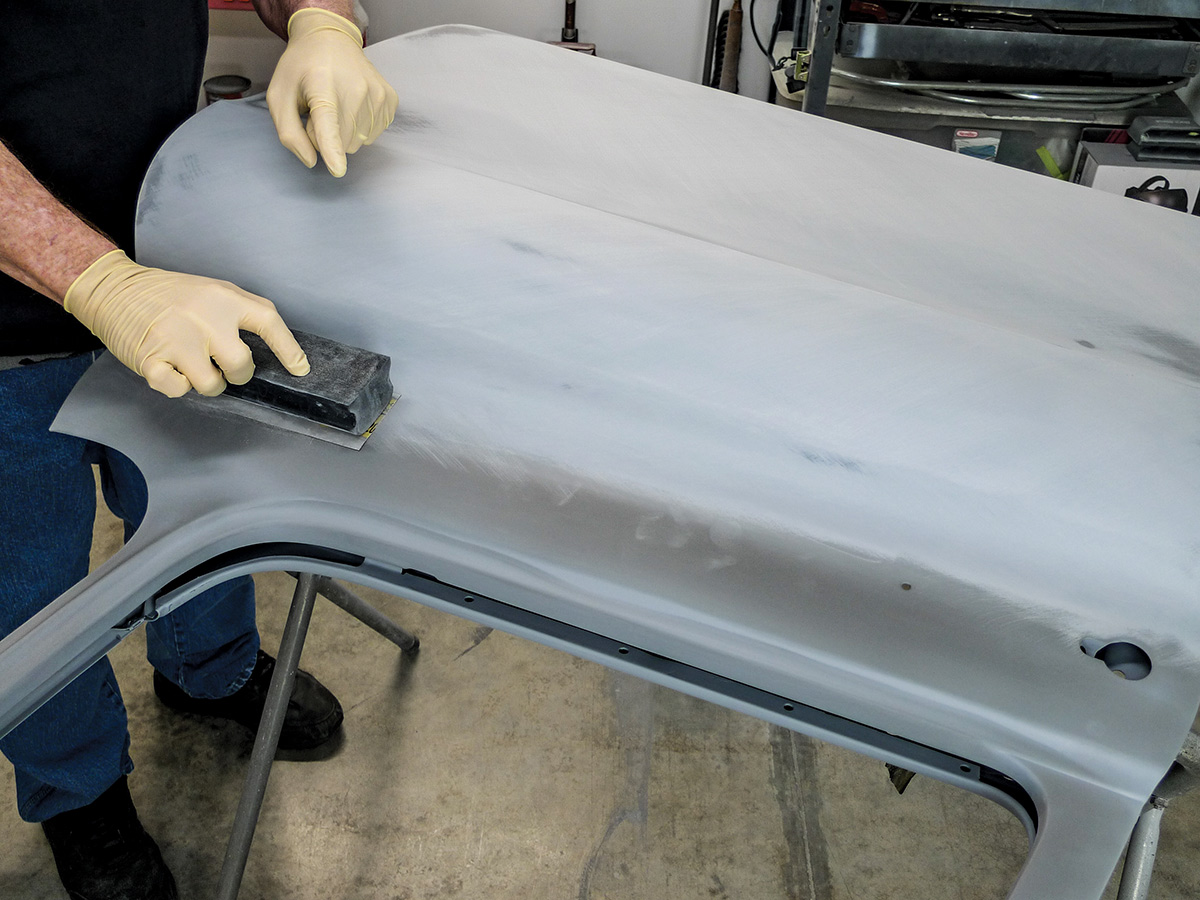 Hands using a fairing block on the exterior of the car door