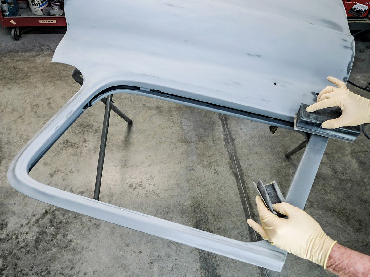 Hands using a fairing block on the exterior of the car door