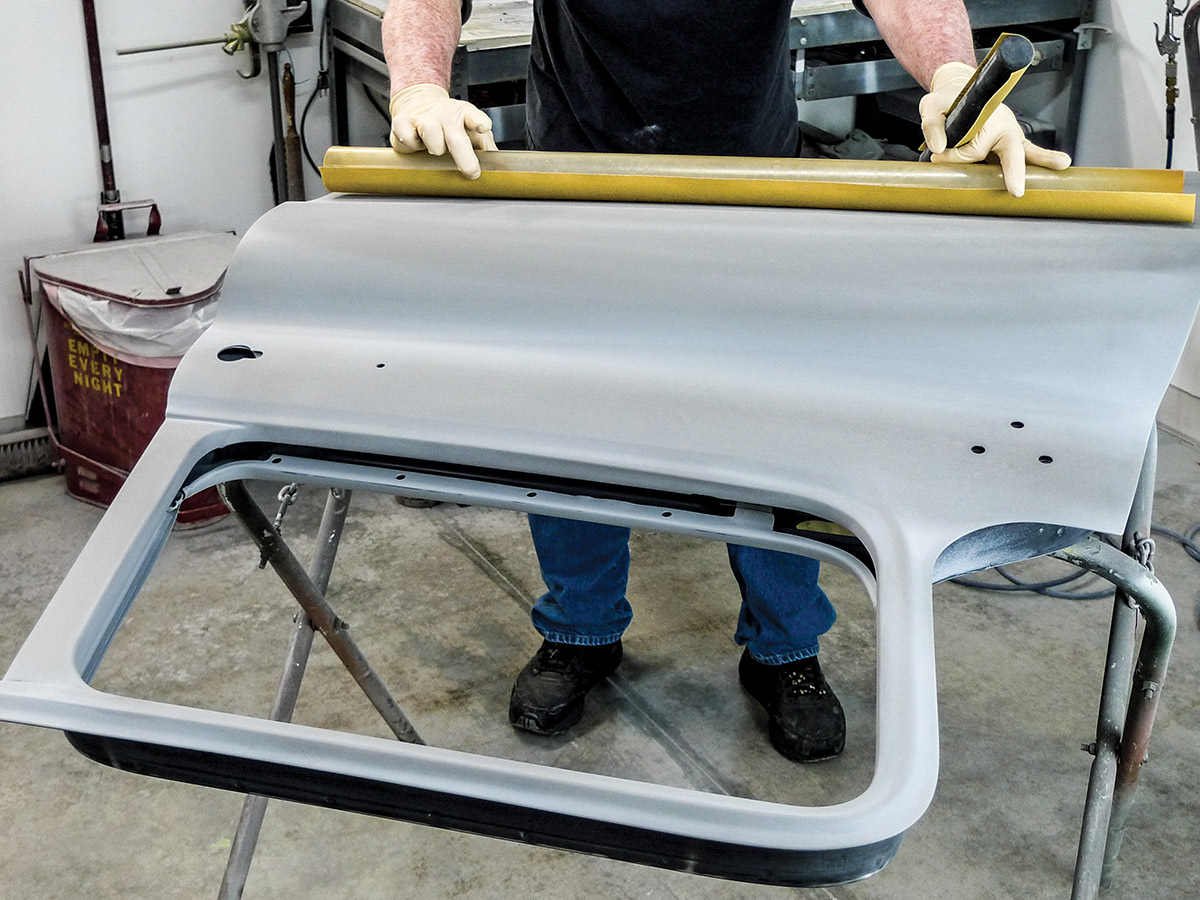 Hands using a fairing block on the exterior of the other car door