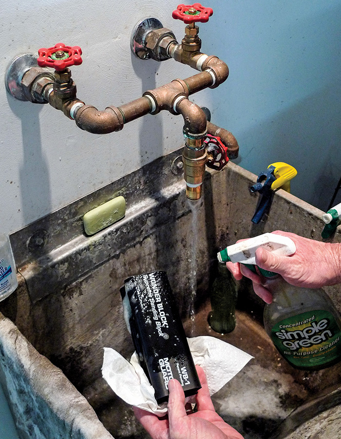 Hands washing the Motor Guard WB-1 in an industrial sink