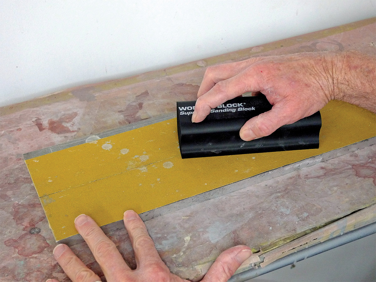 Hands sanding the new Motor Guard WB-1