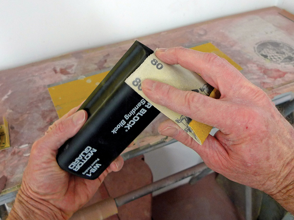 Hands sanding the new Motor Guard WB-1