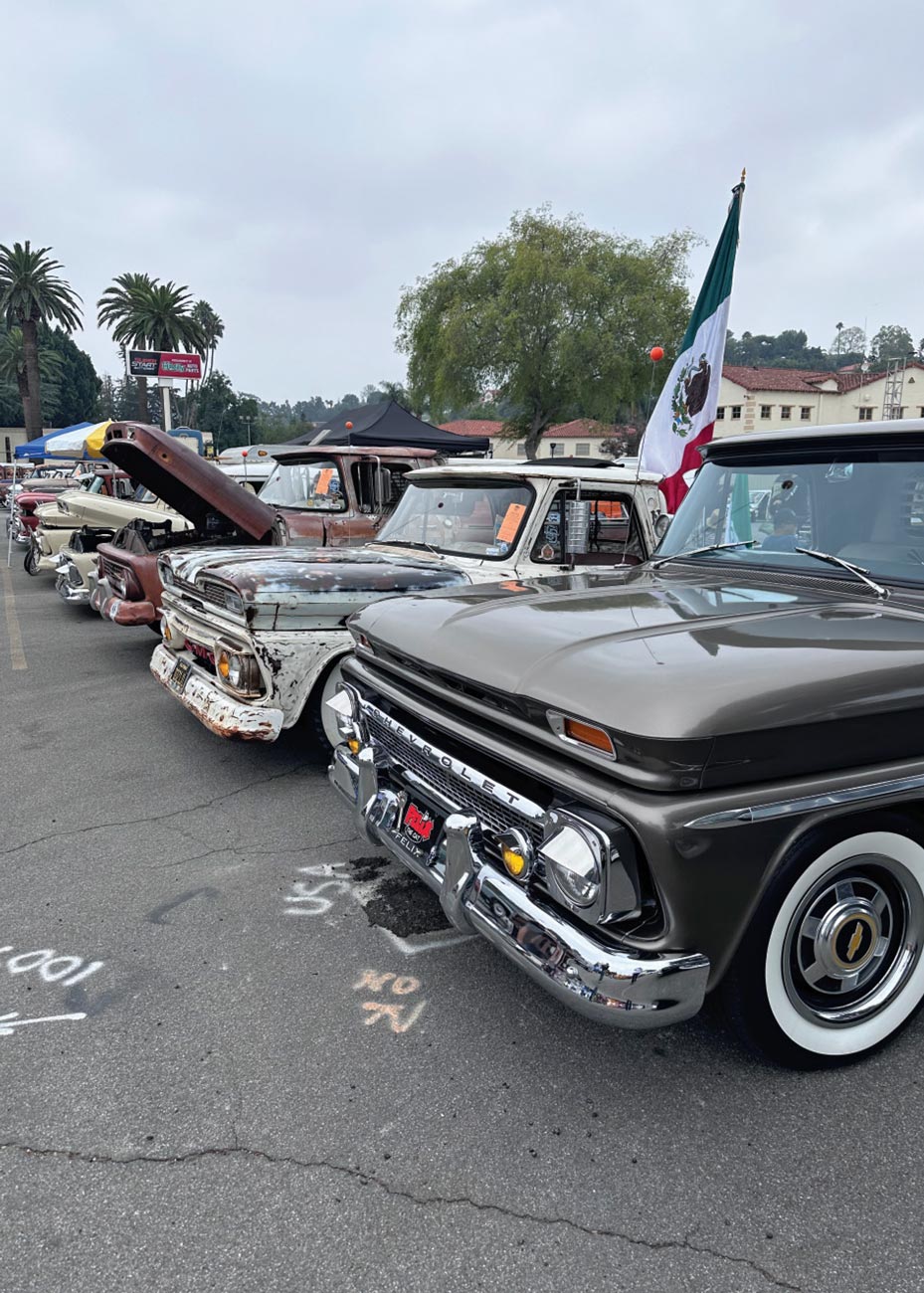a line of classic truck parked on asphalt