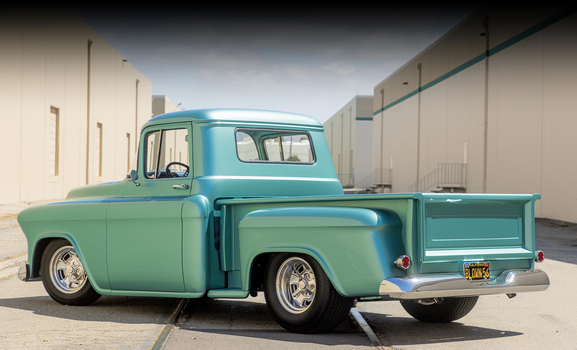 driver side quarter rear view of the sea green ’56 Chevy truck