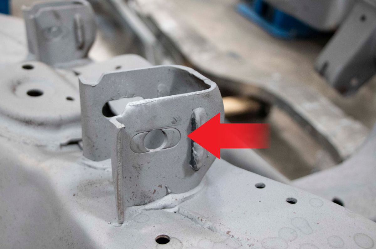 From the factory the GM frame has “knockouts” in the alignment slots (arrow) that limit the range of adjustment that can be made.
