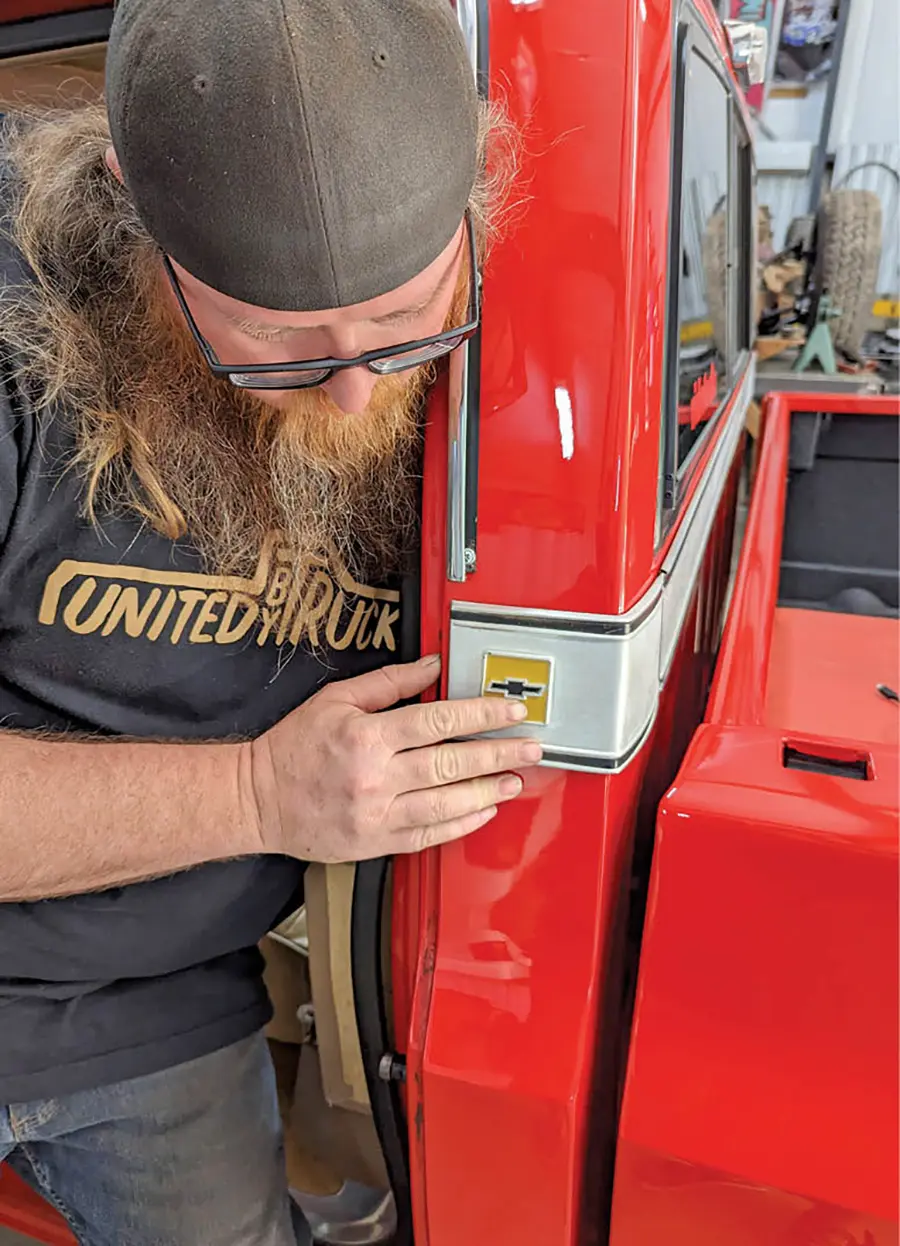 Mike Howe begins by removing the original trim. The corner pieces are accessed through the cab behind the B-pillars and are attached by two speed nuts.