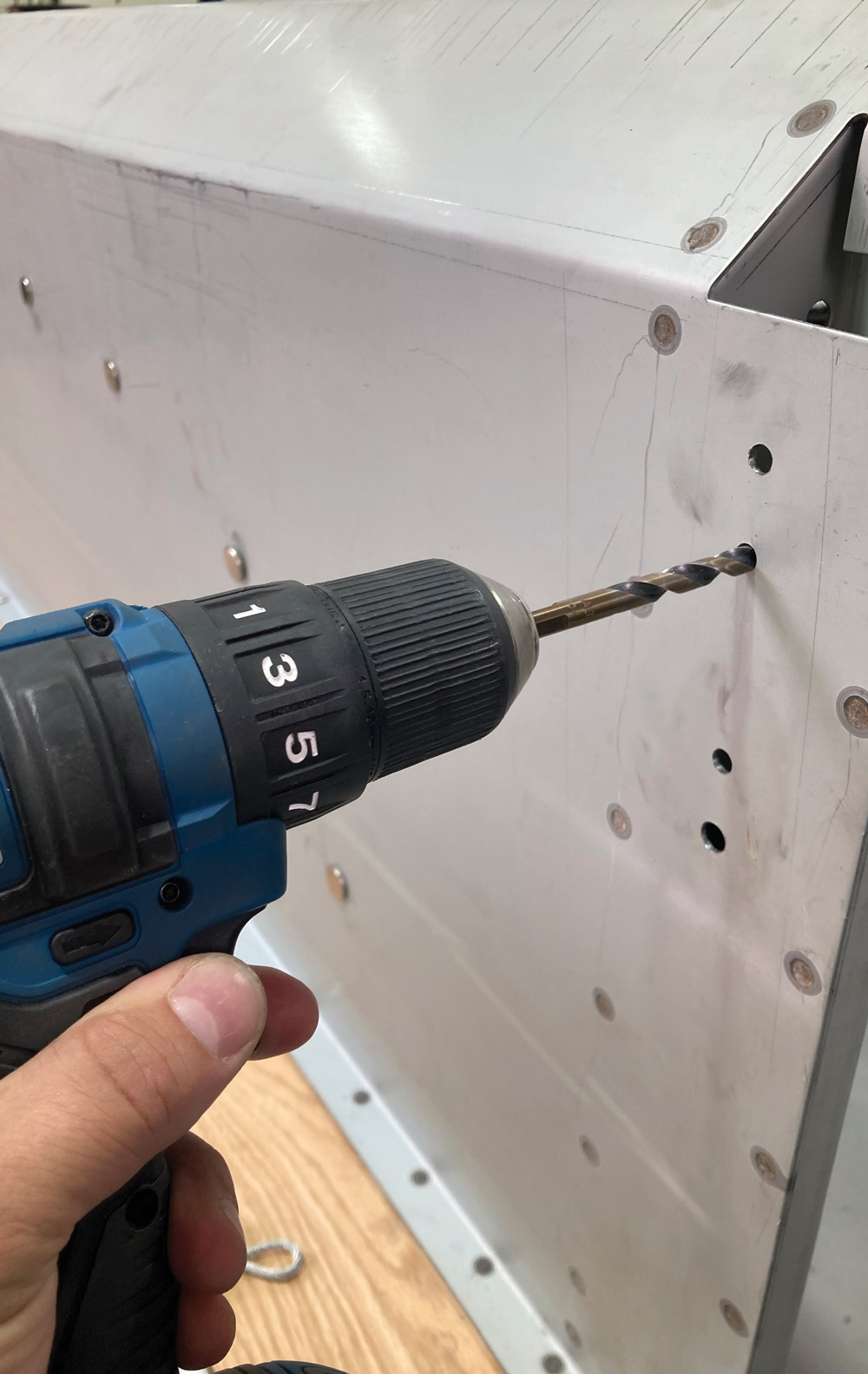 drill being used to make holes