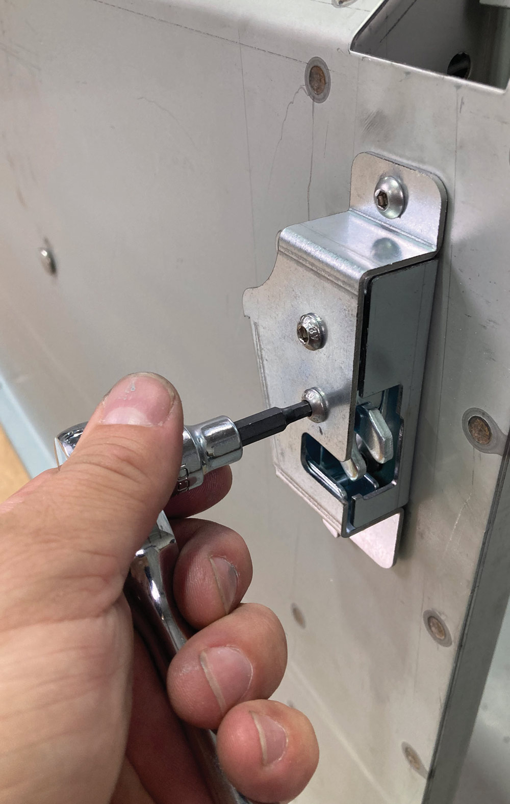 latch being screwed into place