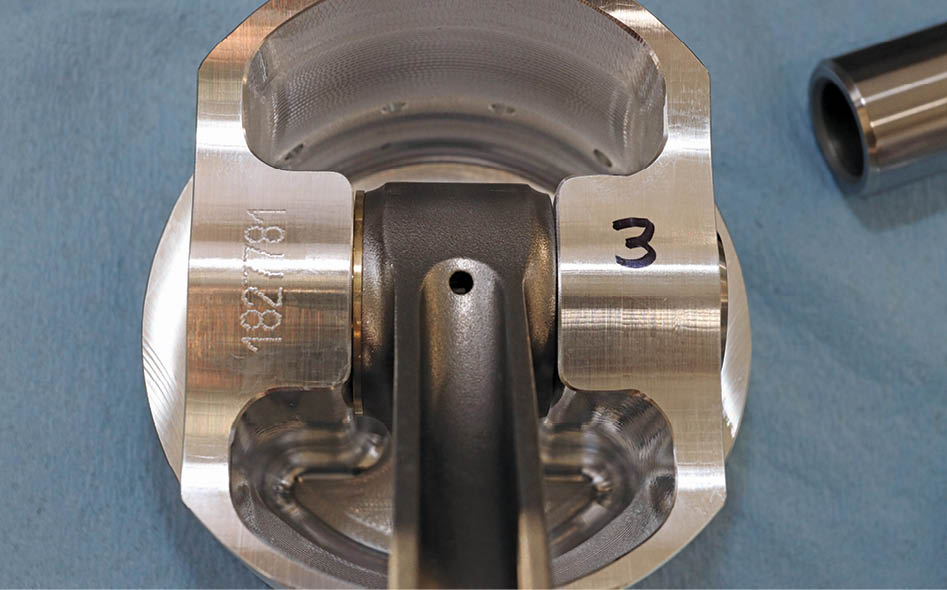 To take care of this, Dorton had the Diamond pistons custom made with the wristpin bosses set to guide the connecting rods longitudinally. You can see the shim on the left side used to dial in the minimum clearance.