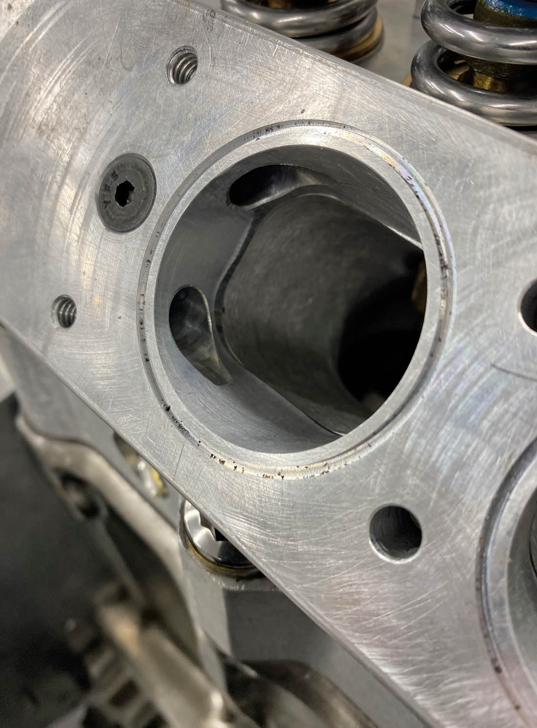 What you can’t see from the previous photo are the castings that guide the air from the Borla throttle bodies don’t mount directly to the Wayne cylinder head. Instead, they bolt to this intermediate plate that bolts to the head. The purpose of the plate is to provide ports that connect all six intake runners. This creates a balance chamber, which helps the engine run more smoothly.
