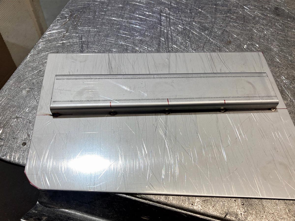 With the top, bottom, and internals of the tank all in place, the side panels are laser cut and also tacked into position.