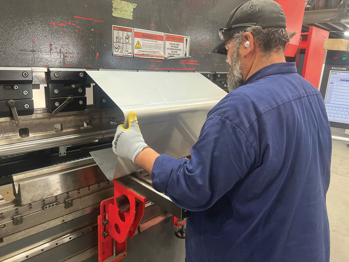 The larger bottom section of the tank was formed on a CNC press/brake. Measurements are constantly checked and confirmed through the hand-formed process.