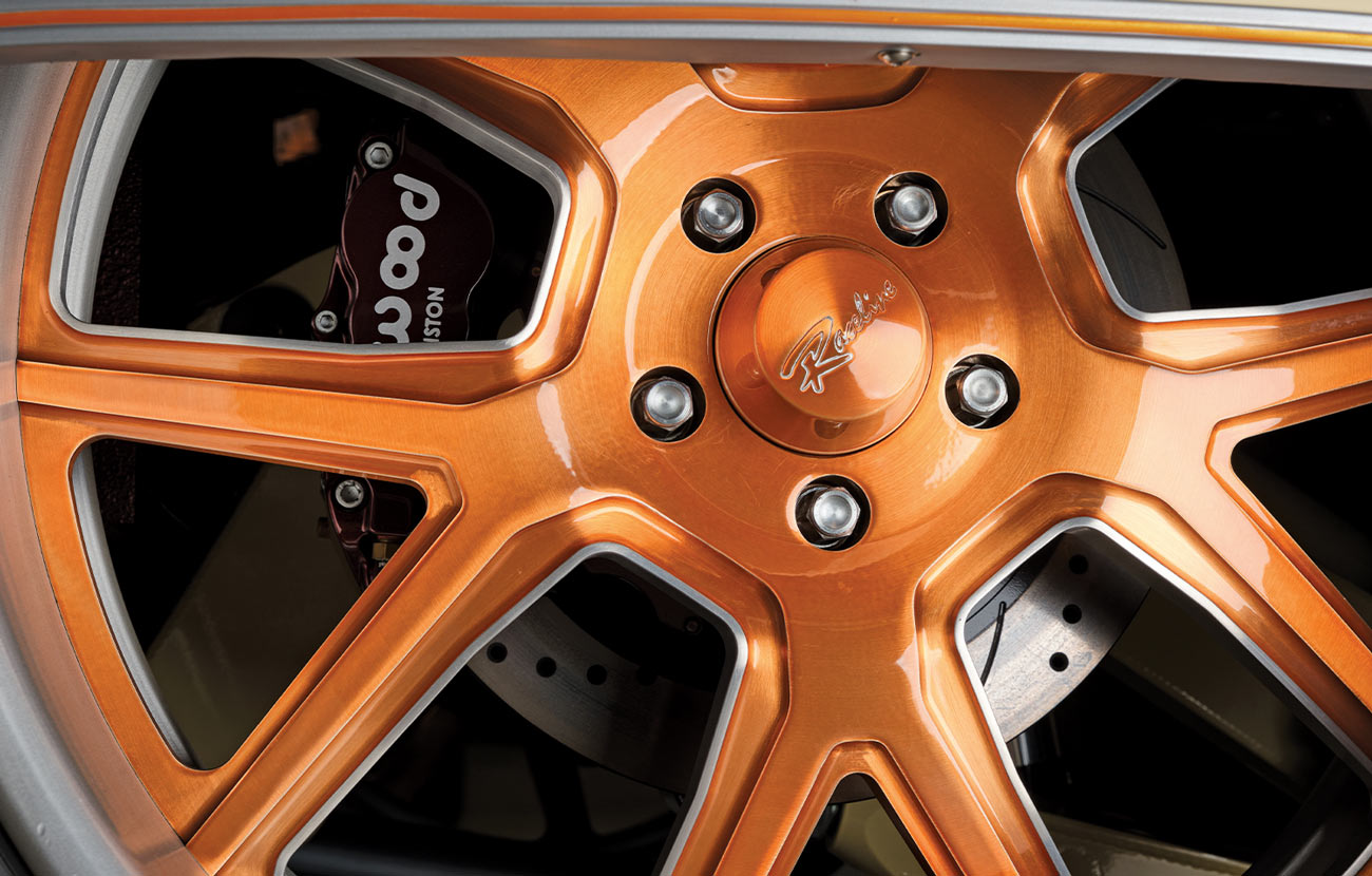 close view of one of the Square Unibody C10's orange glaze coated Raceline rims