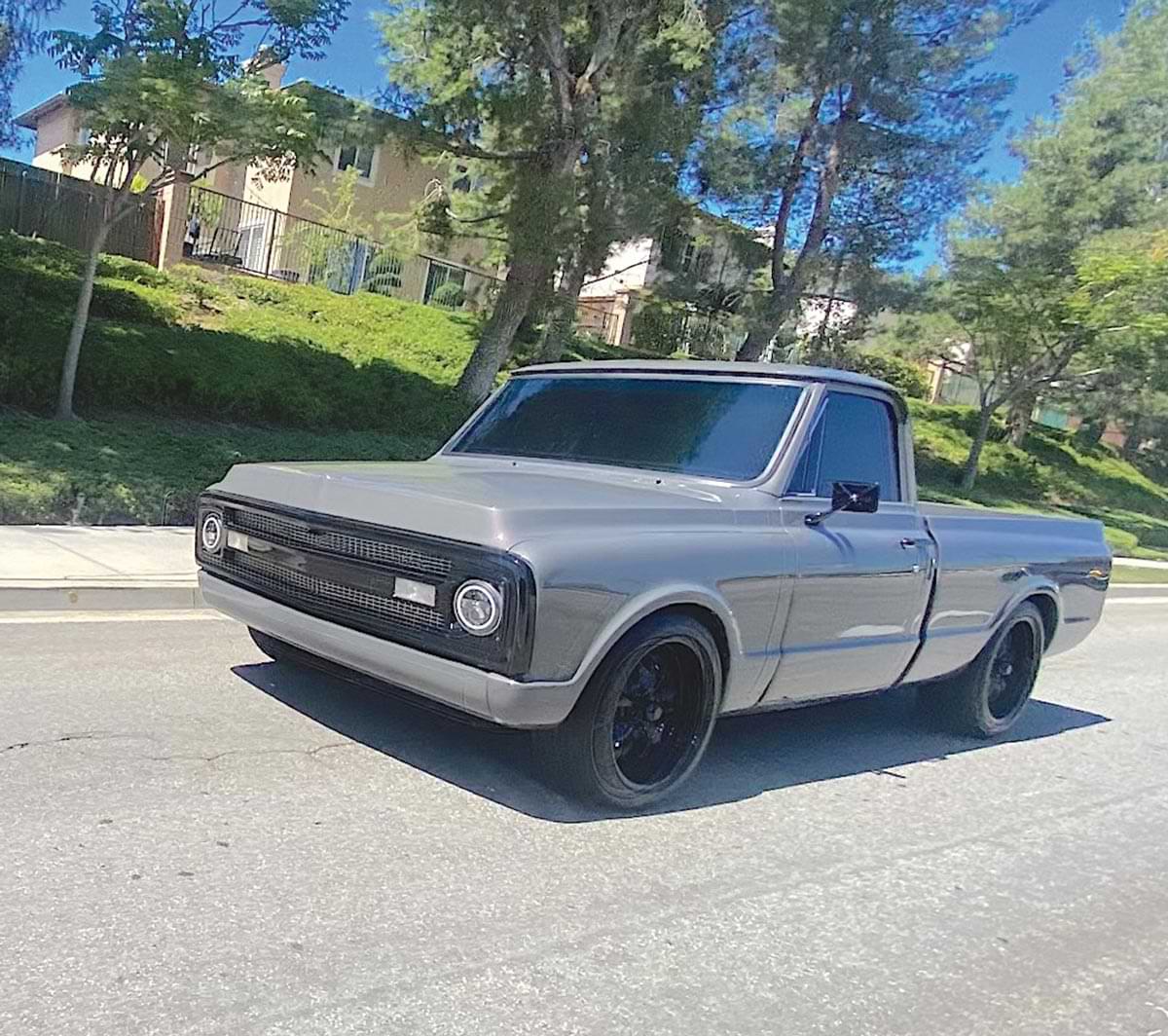 quarter view of a grey GM C10 truck on a residential street