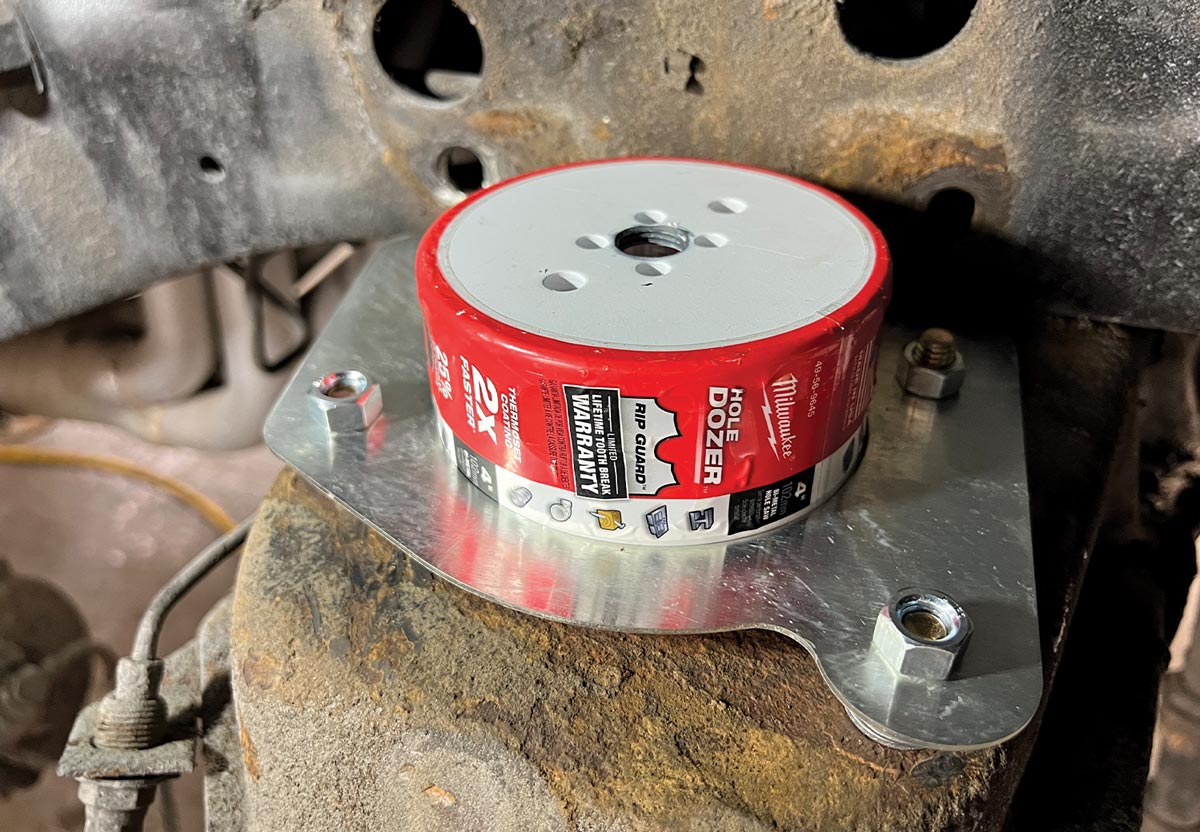 a 4-inch hole saw dia is placed on the crossmember trim plate