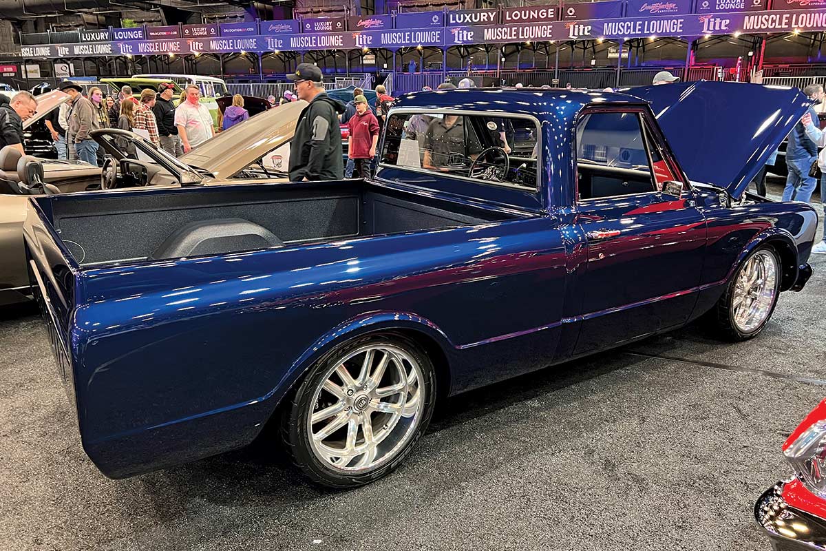 rear view of royal blue pickup truck with hood propped open