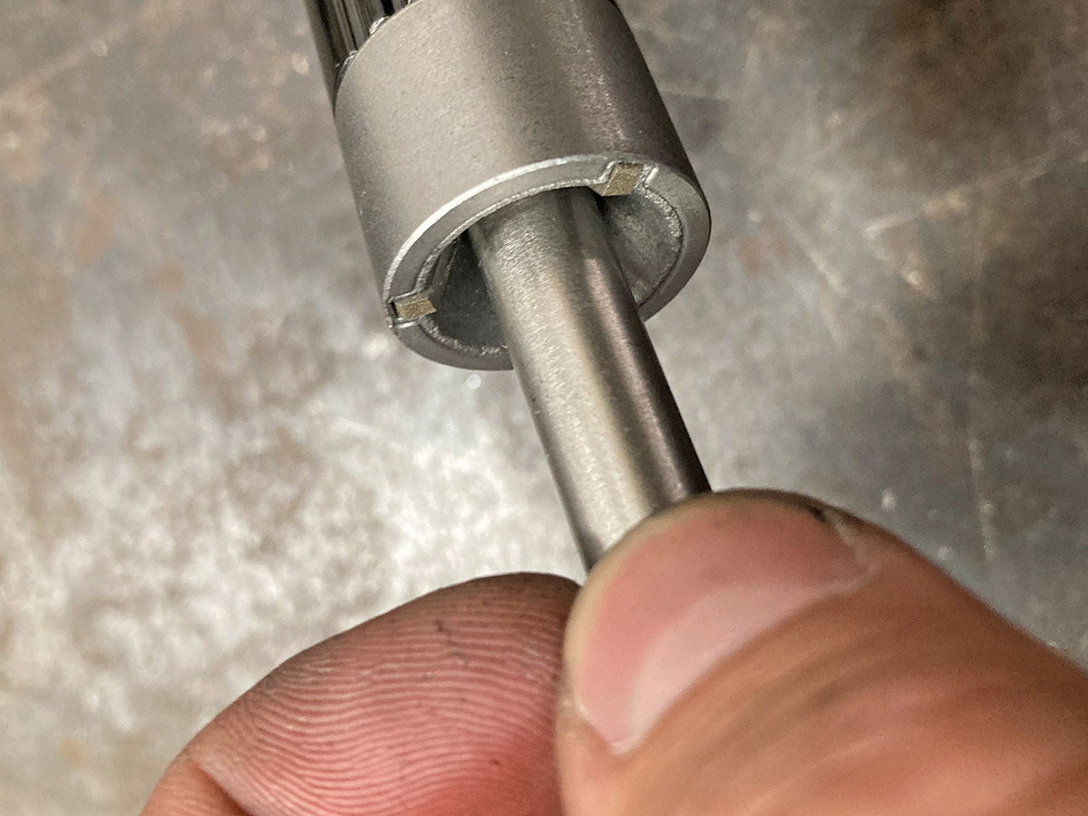 closeup of fingers holding tube to deburring tool