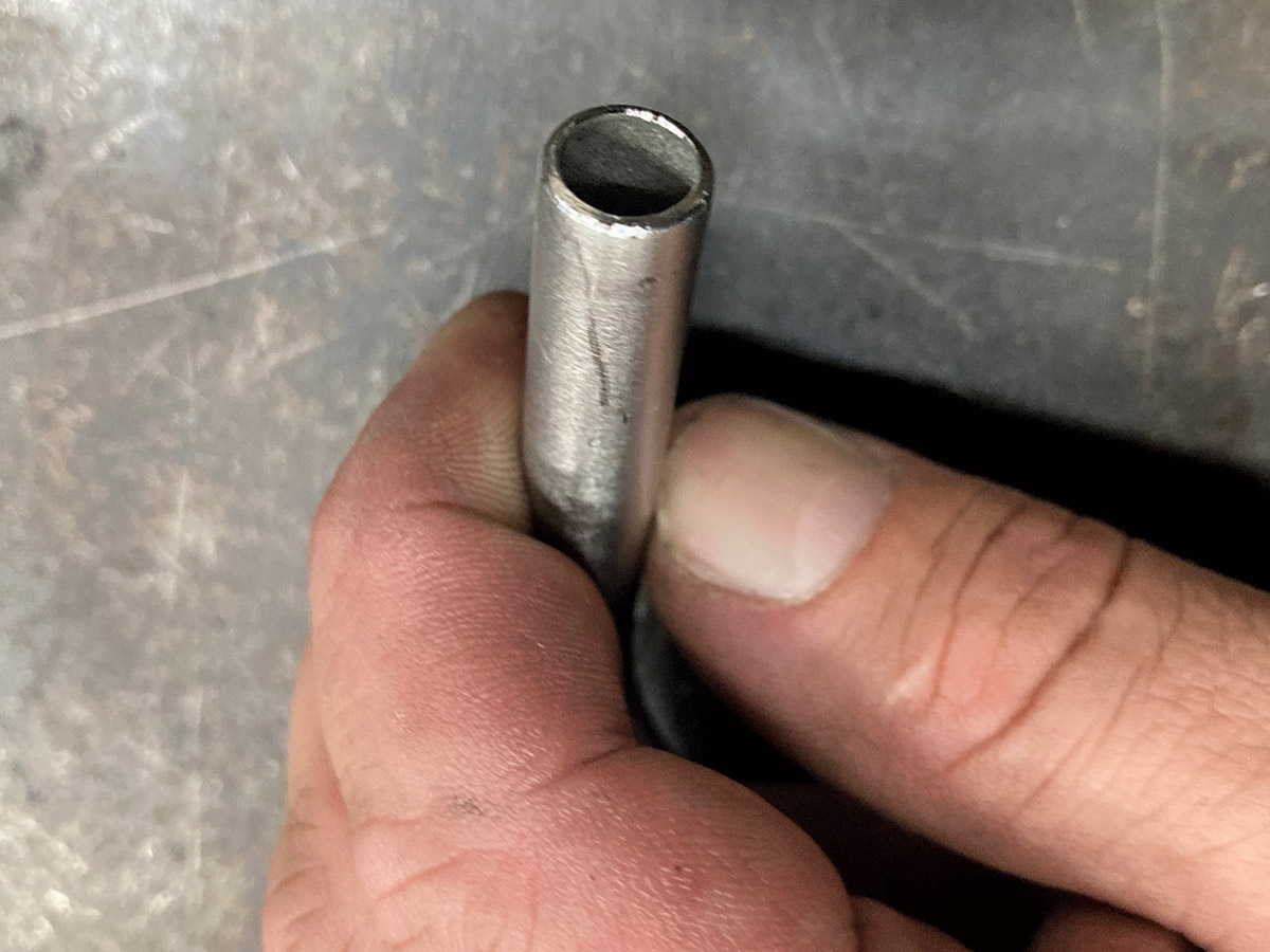 hand holding finished deburred tube