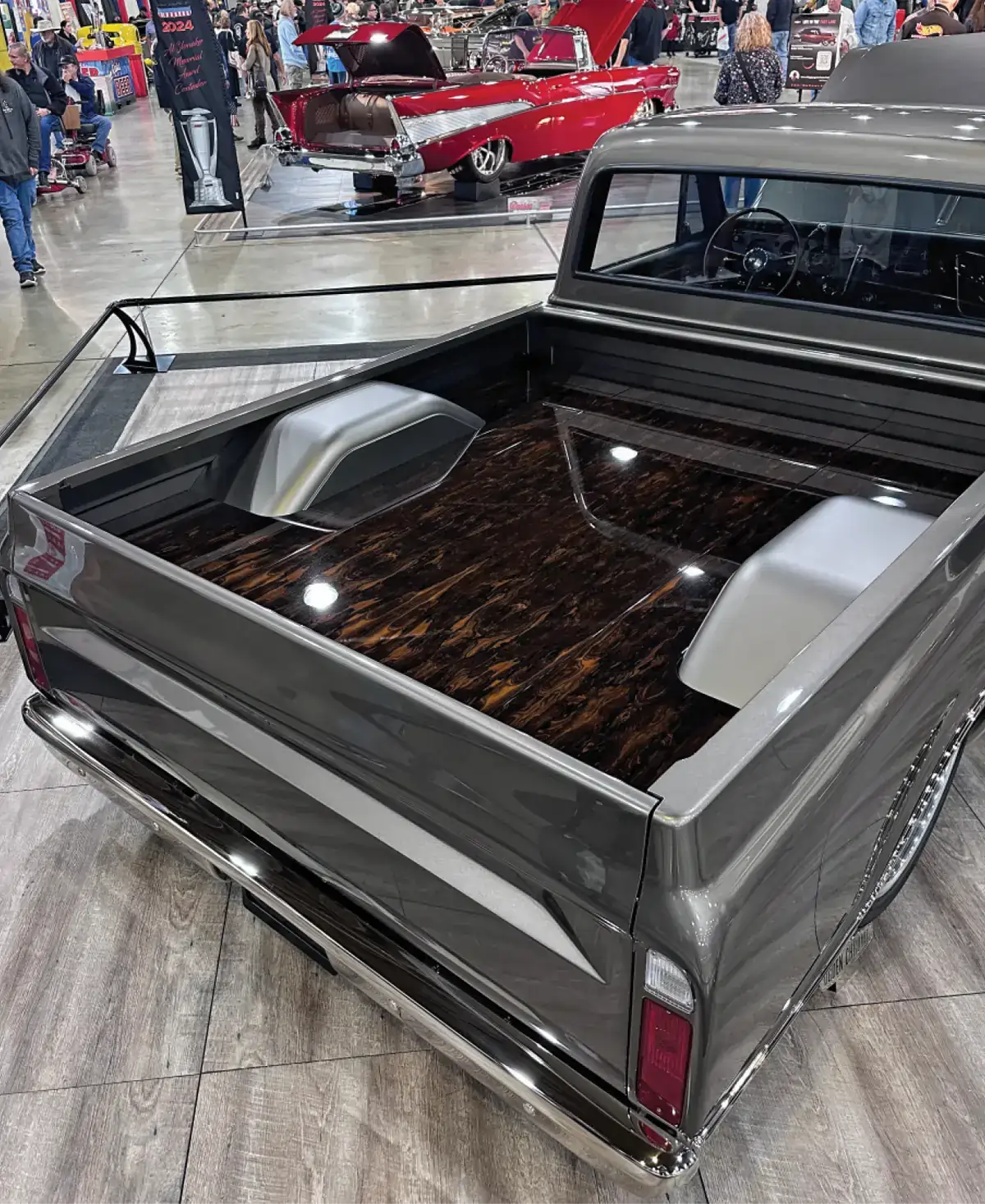 rear view of the wood based bed of the two toned grey, low riding chevy truck