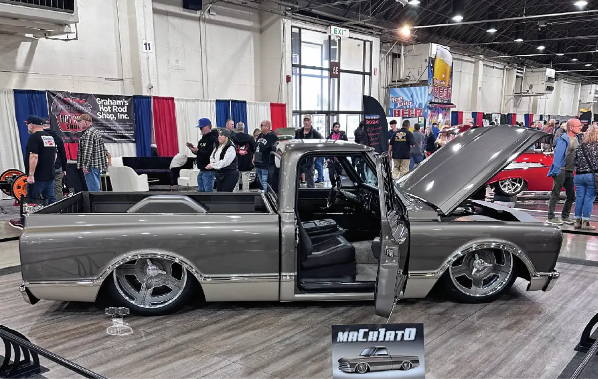 passenger side profile of the two toned grey, low riding chevy truck with its passenger door and front hood open