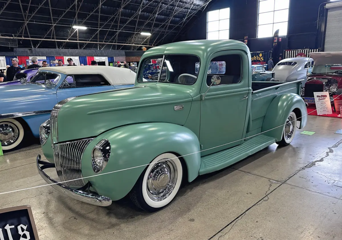 quarter driver side of a muted green classic truck
