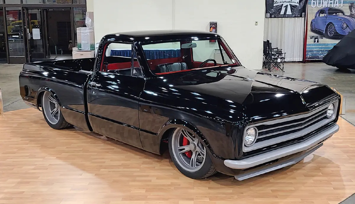 quarter passenger side of a glossy black Chevy classic truck