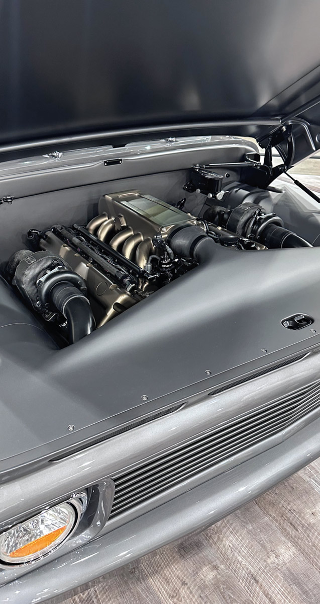 close view of the engine of a dark grey classic truck