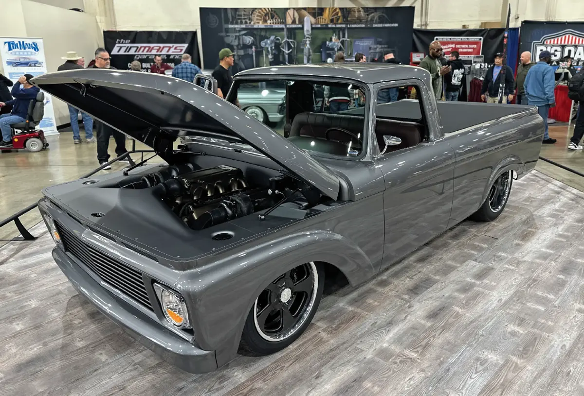 front quarter driver side of the dark grey classic truck with its hood open