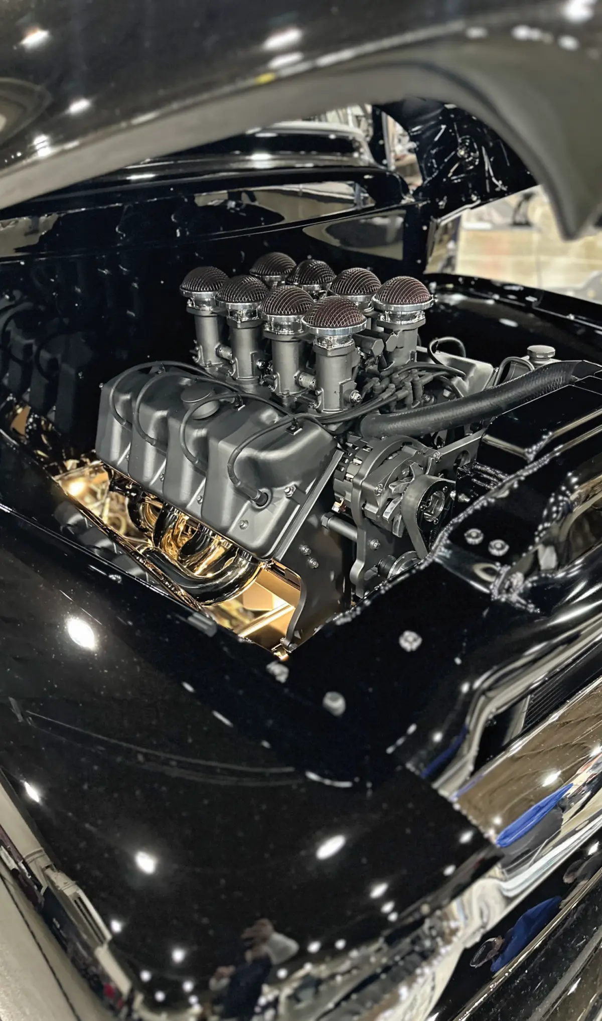 zoomed view at the glossy black classic truck's engine