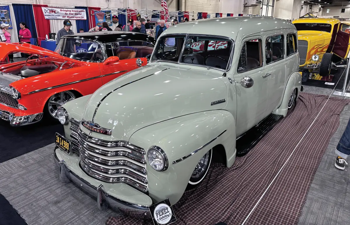 quarter driver side of a pale grey classic Chevy suburban