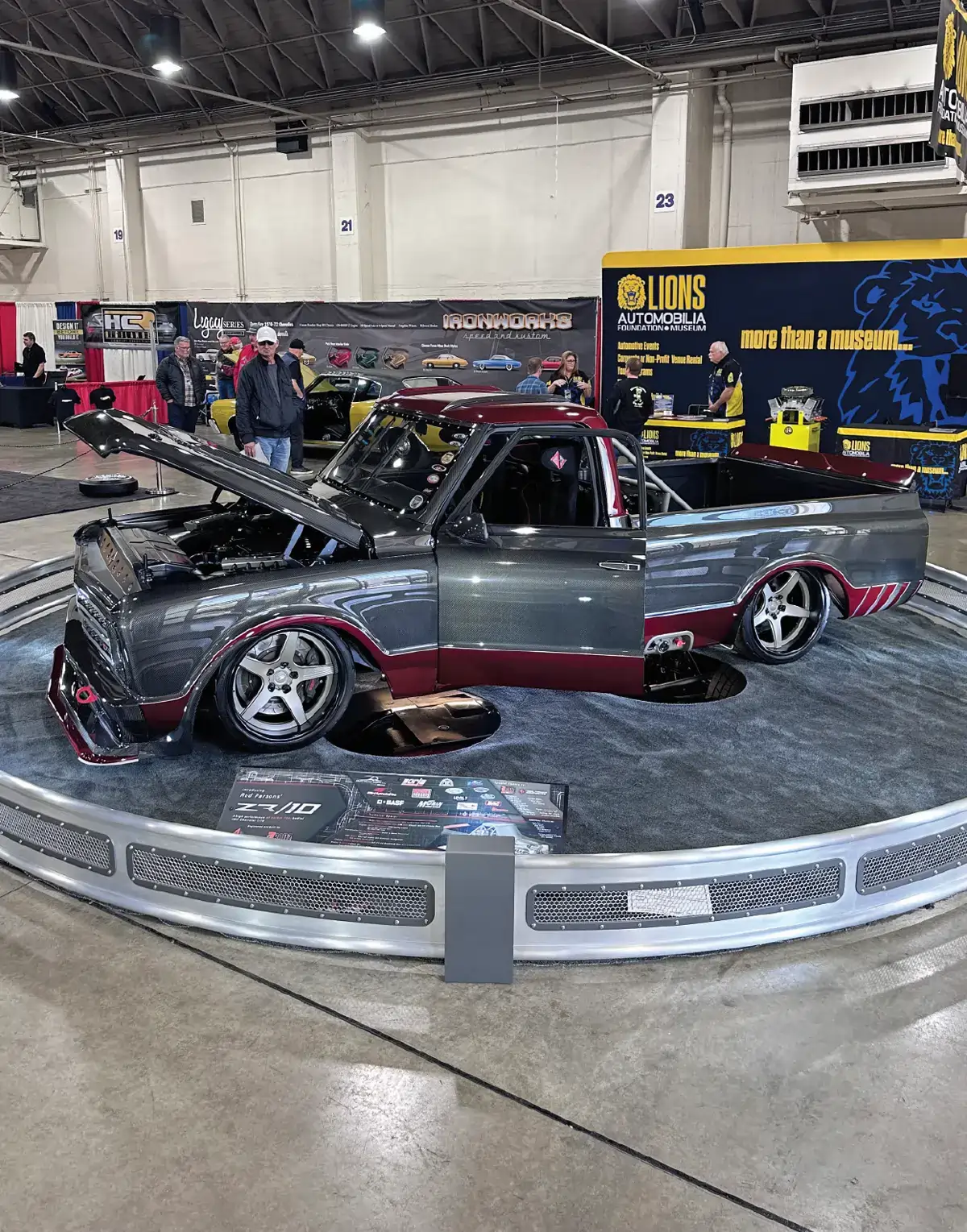 quarter driver side of a grey and maroon classic Chevy truck