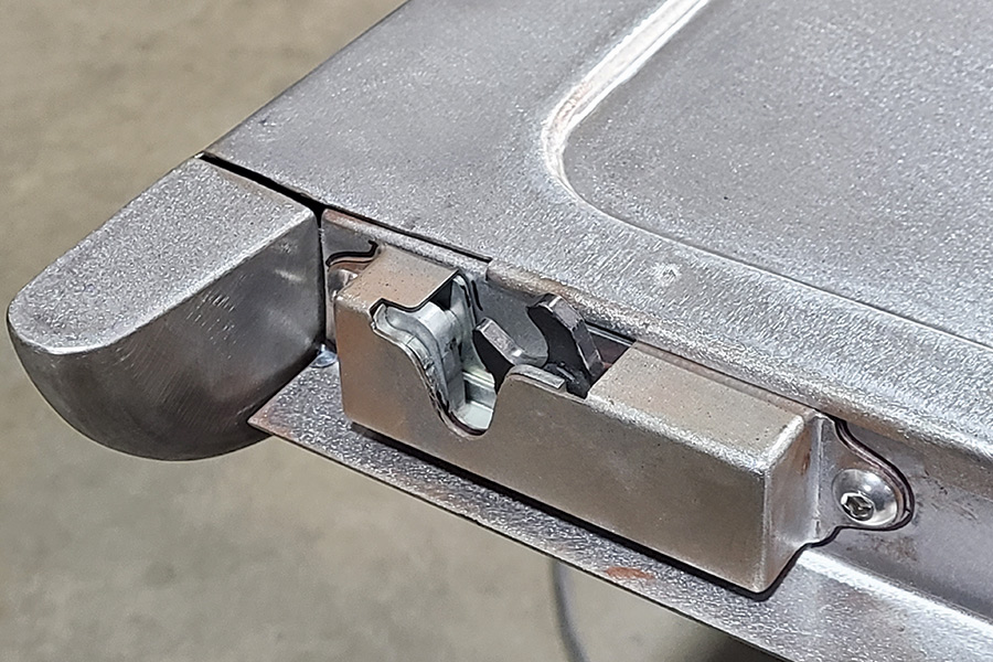 latch bolt with housing attached to tailgate