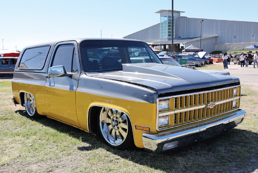 black truck with lower body yellow stripe and trunk cover