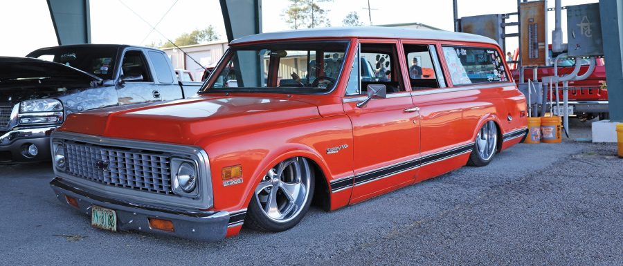 side profile of red station wagon with white roof