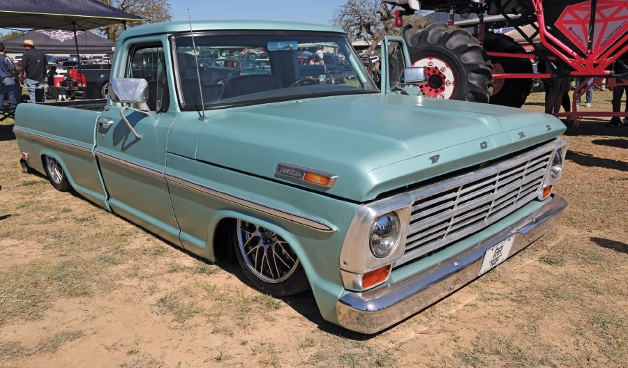 light blue truck on grass and dirt field