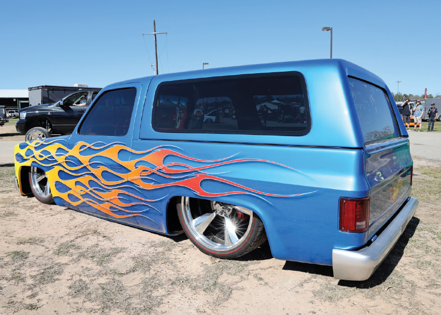 blue truck with trunk cover and orange and yellows flames