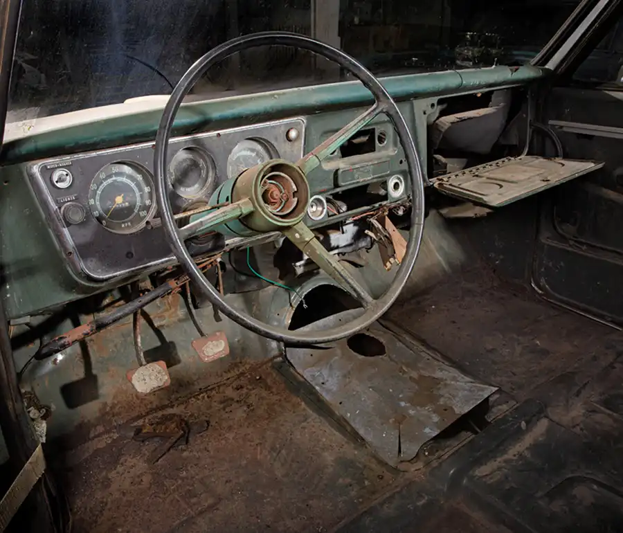 The “interior”—or what was left of one. The homemade galvanized transmission tunnel wasn’t going to cut it. Neither was the seatbelt serving as the driver door limiter.