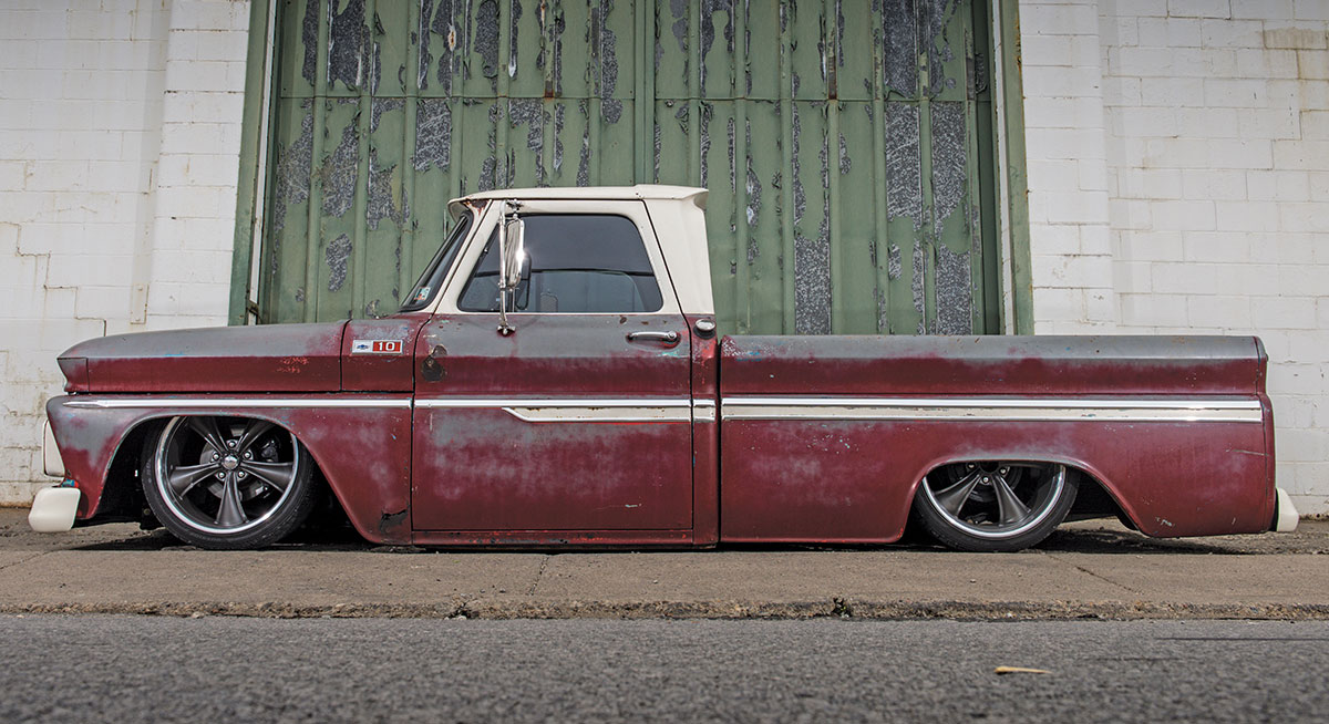 side view of red and white '65 C10 truck