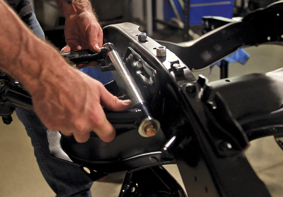 person handling a set of tubular upper and lower control arms