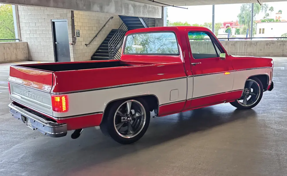 passenger side profile of a retro red and white class Chevy truck